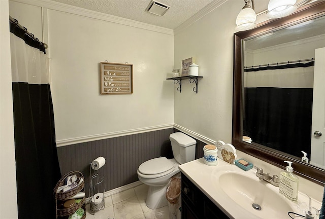 bathroom with toilet, crown molding, a textured ceiling, vanity, and tile patterned flooring