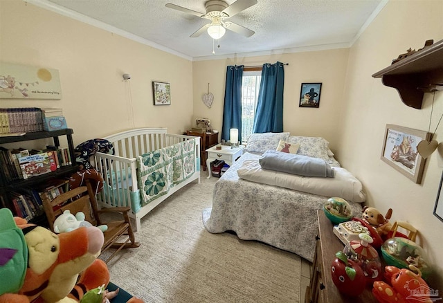 carpeted bedroom with crown molding, ceiling fan, and a textured ceiling