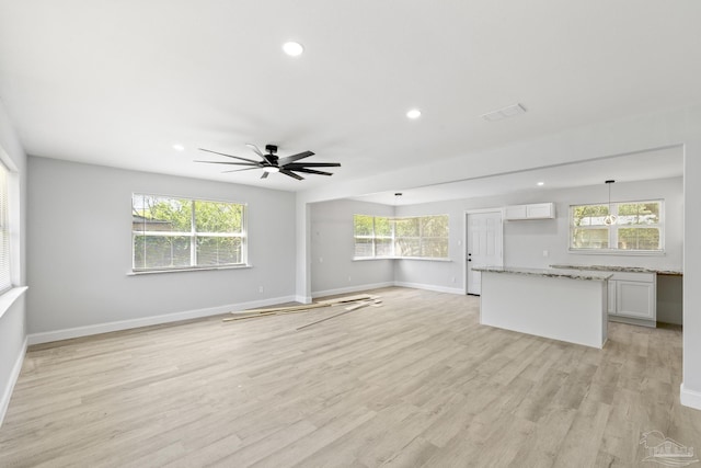 1029 Kearny Dr, Pensacola, FL 32505 - unfurnished living room with ceiling fan, light wood-style floors, and baseboards