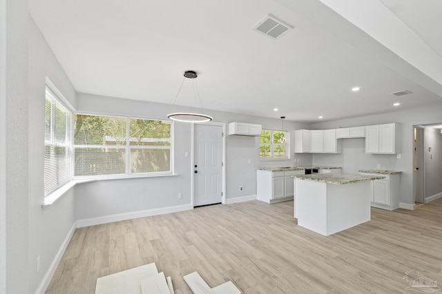1029 Kearny Dr, Pensacola, FL 32505 - kitchen with baseboards, visible vents, a center island, and light wood-style flooring