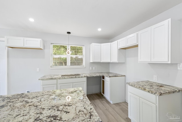 1029 Kearny Dr, Pensacola, FL 32505 - kitchen featuring recessed lighting, light stone countertops, white cabinetry, and light wood-style floors