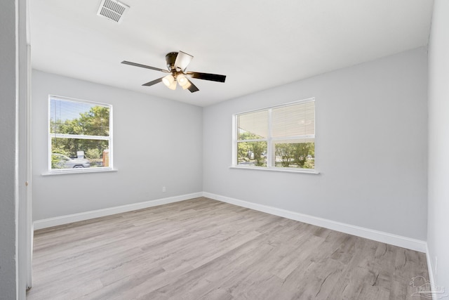 1029 Kearny Dr, Pensacola, FL 32505 - empty room with light wood finished floors, visible vents, baseboards, and a healthy amount of sunlight