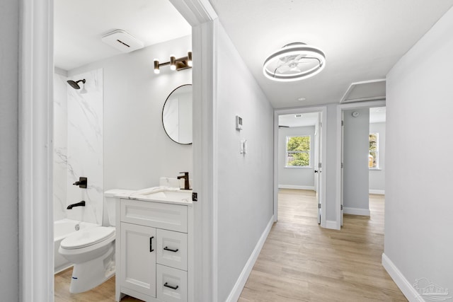 1029 Kearny Dr, Pensacola, FL 32505 - bathroom with wood finished floors,  shower combination, toilet, vanity, and baseboards
