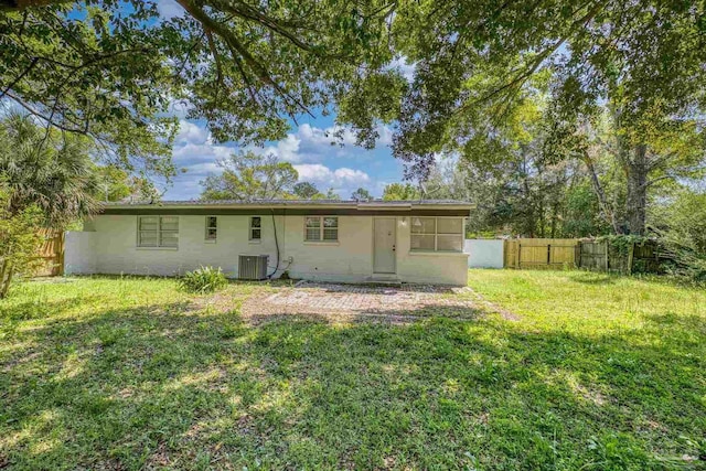 1029 Kearny Dr, Pensacola, FL 32505 - back of house featuring a fenced backyard, central AC unit, and a yard