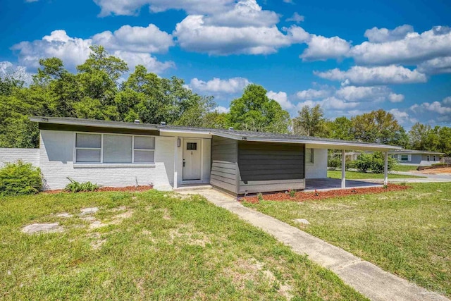 1029 Kearny Dr, Pensacola, FL 32505 - single story home featuring a front lawn, a carport, and brick siding