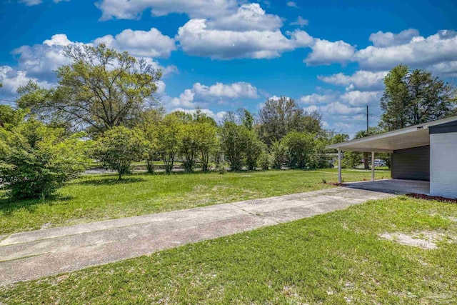 1029 Kearny Dr, Pensacola, FL 32505 - view of yard featuring concrete driveway and a carport