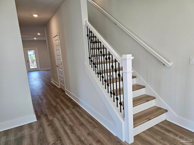 stairway with recessed lighting, wood finished floors, and baseboards