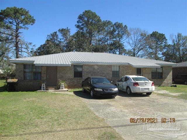 929 Bremen Ave Unit A & B, Pensacola, FL 32507 - ranch-style home featuring metal roof, a front yard, and driveway