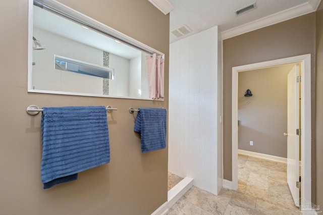 bathroom featuring tiled shower and ornamental molding