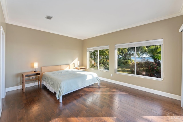 bedroom featuring dark wood-type flooring and crown molding