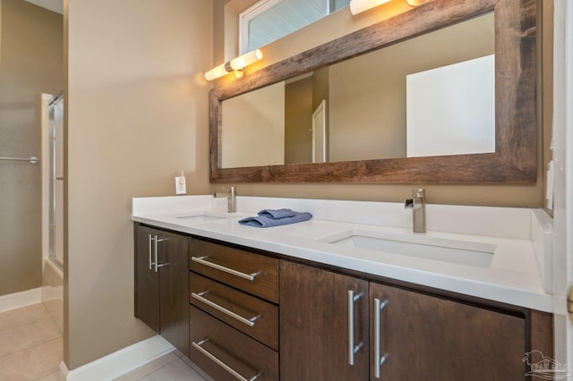 bathroom with vanity, shower / bath combination with glass door, and tile patterned flooring