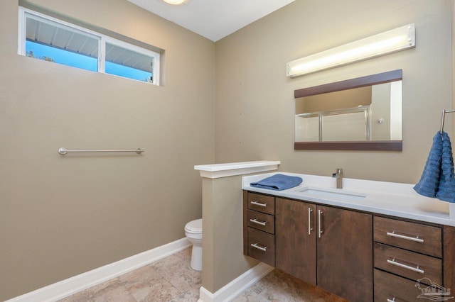 bathroom with toilet, a shower with door, and vanity