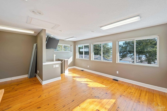 interior space featuring a textured ceiling and hardwood / wood-style flooring