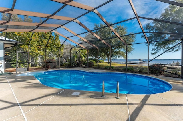 view of pool featuring a patio, a lanai, and a water view