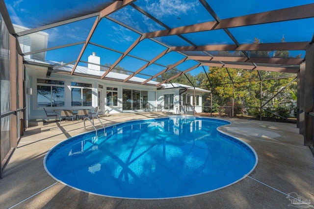 view of pool featuring a patio area and glass enclosure