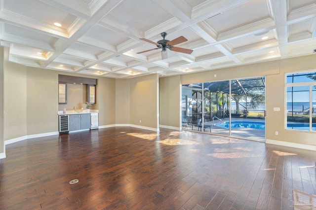 unfurnished living room featuring beam ceiling, dark hardwood / wood-style flooring, and coffered ceiling