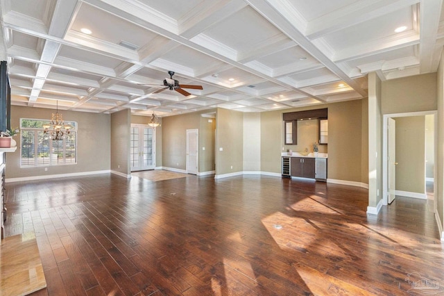 unfurnished living room with coffered ceiling, beam ceiling, and dark hardwood / wood-style floors