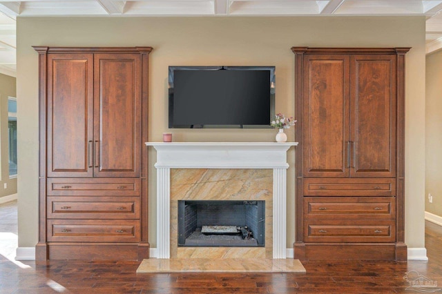 unfurnished living room featuring a high end fireplace, ornamental molding, and dark hardwood / wood-style floors