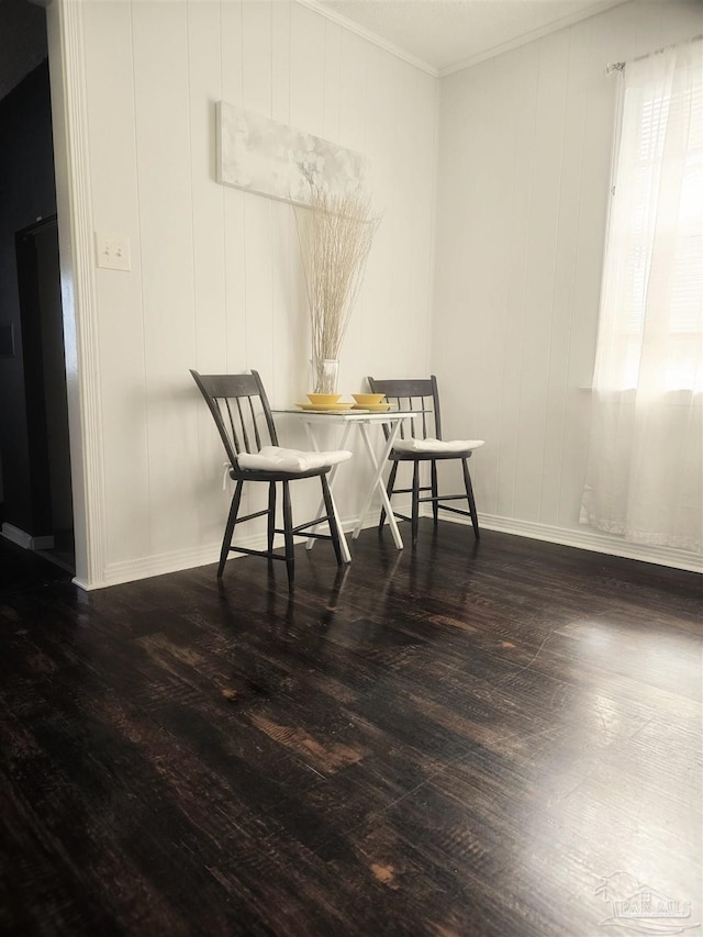 dining area with dark hardwood / wood-style flooring and ornamental molding