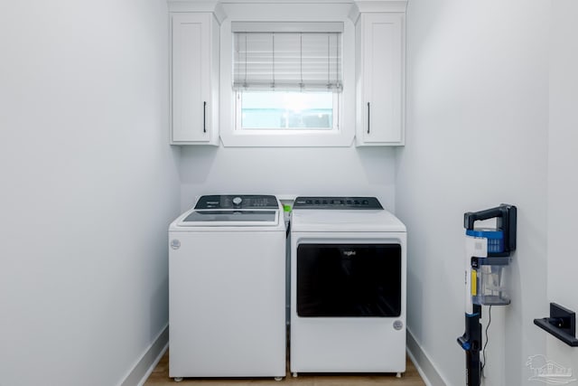 laundry room with cabinets and separate washer and dryer