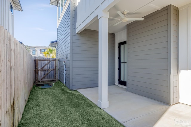 view of property exterior featuring a patio, ceiling fan, and a lawn