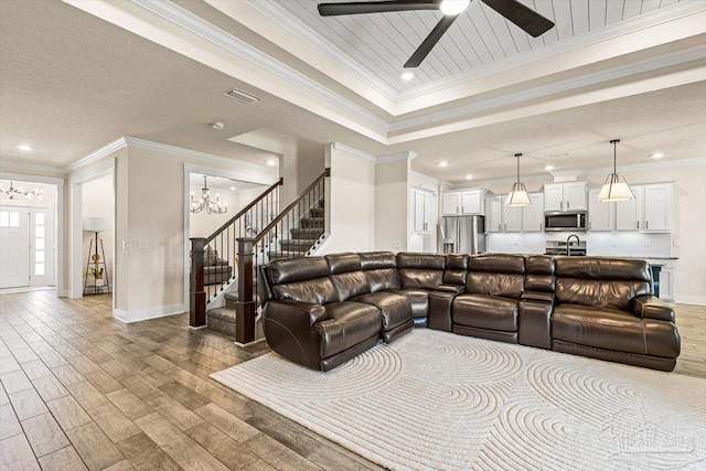 1412 Areca Palm Dr, Gulf Breeze, FL 32563 - living area featuring stairs, crown molding, light wood-style floors, ceiling fan, and a chandelier