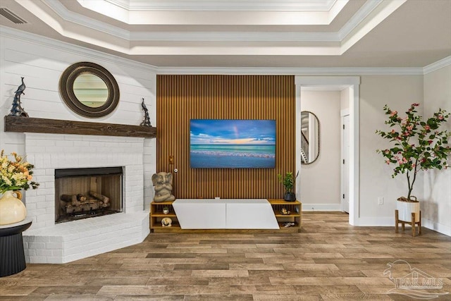 1412 Areca Palm Dr, Gulf Breeze, FL 32563 - living room with a tray ceiling, wood finished floors, crown molding, and a fireplace