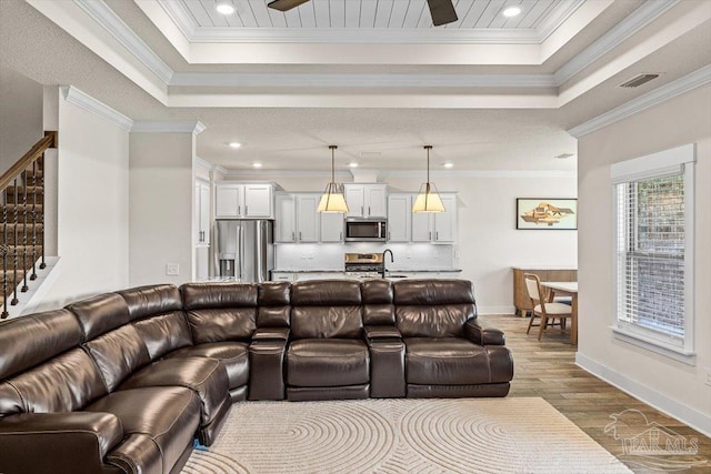 1412 Areca Palm Dr, Gulf Breeze, FL 32563 - living area with a raised ceiling, stairway, dark wood-style flooring, recessed lighting, and crown molding