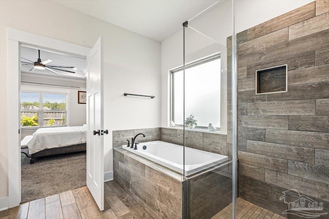 1412 Areca Palm Dr, Gulf Breeze, FL 32563 - ensuite bathroom featuring a garden tub, wood finished floors, a stall shower, and a ceiling fan
