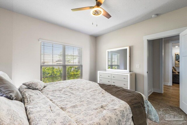 1412 Areca Palm Dr, Gulf Breeze, FL 32563 - bedroom with wood finished floors and ceiling fan
