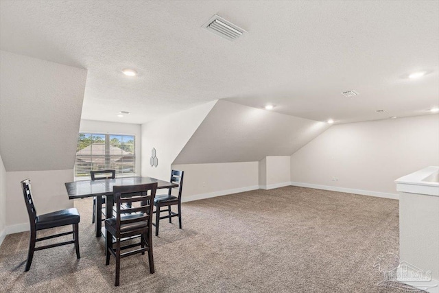 1412 Areca Palm Dr, Gulf Breeze, FL 32563 - carpeted dining room with vaulted ceiling, a textured ceiling, and recessed lighting