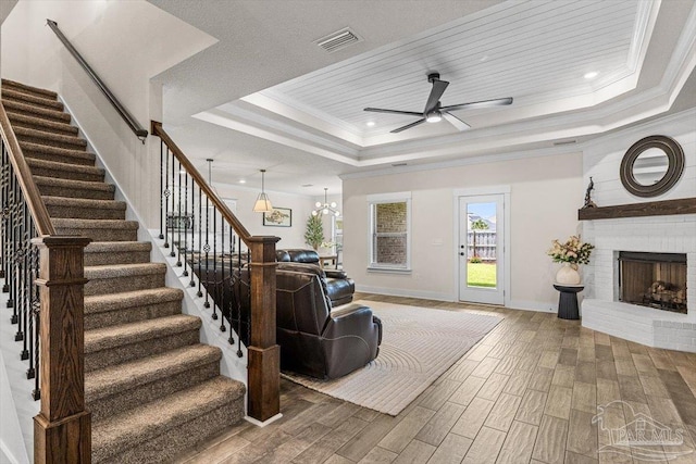 1412 Areca Palm Dr, Gulf Breeze, FL 32563 - living room with a tray ceiling, wood finished floors, stairs, a ceiling fan, and crown molding