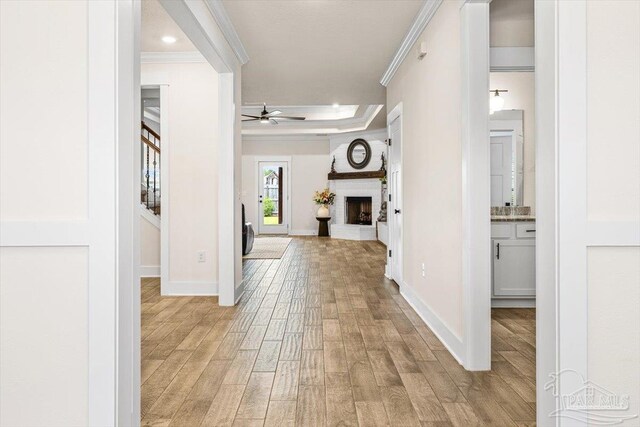1412 Areca Palm Dr, Gulf Breeze, FL 32563 - hallway with light wood finished floors, ornamental molding, stairs, a raised ceiling, and recessed lighting