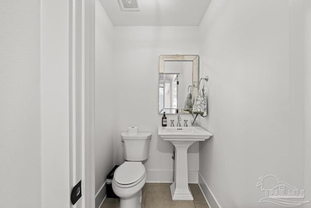 bathroom with tile patterned floors and toilet