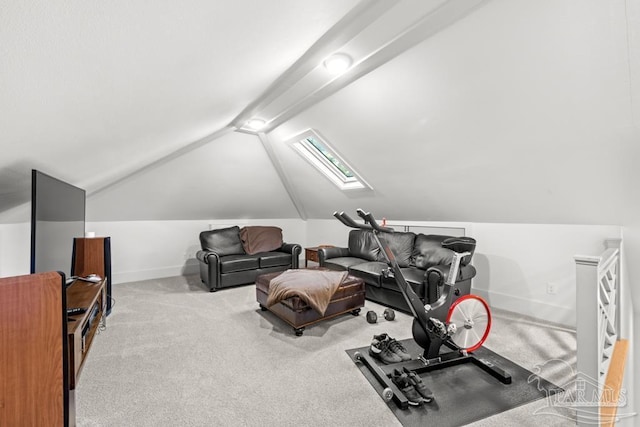 workout area featuring lofted ceiling with skylight and light carpet