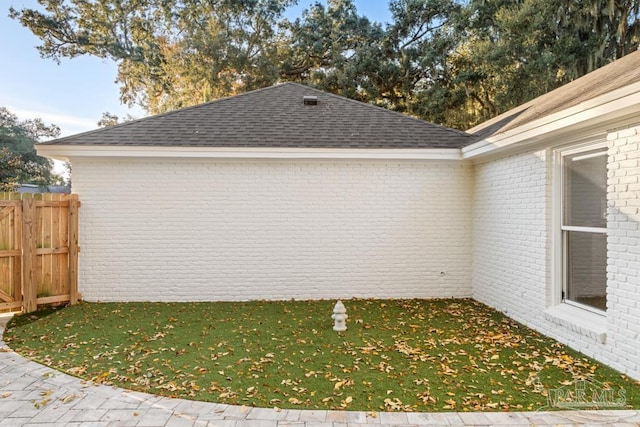 view of side of property with a lawn