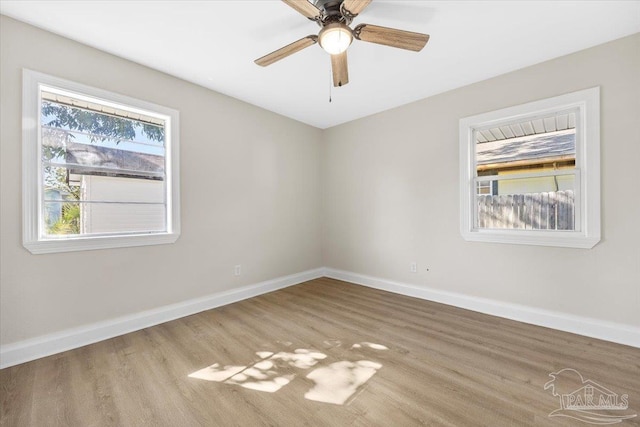 unfurnished room with light hardwood / wood-style flooring, a wealth of natural light, and ceiling fan