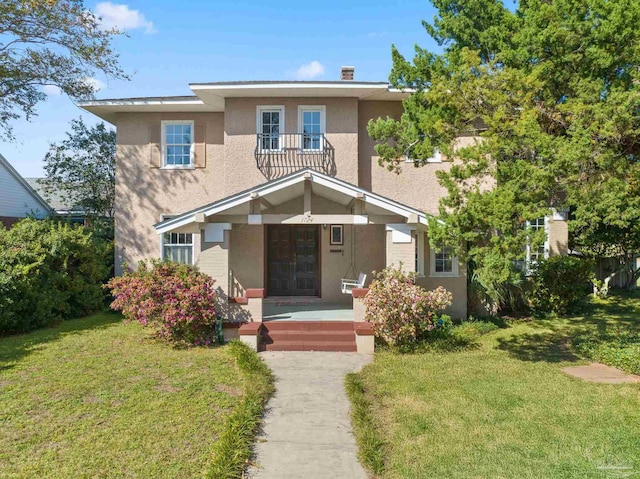 view of front of property featuring a porch and a front lawn