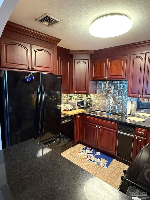 kitchen featuring a textured ceiling, sink, backsplash, and black appliances