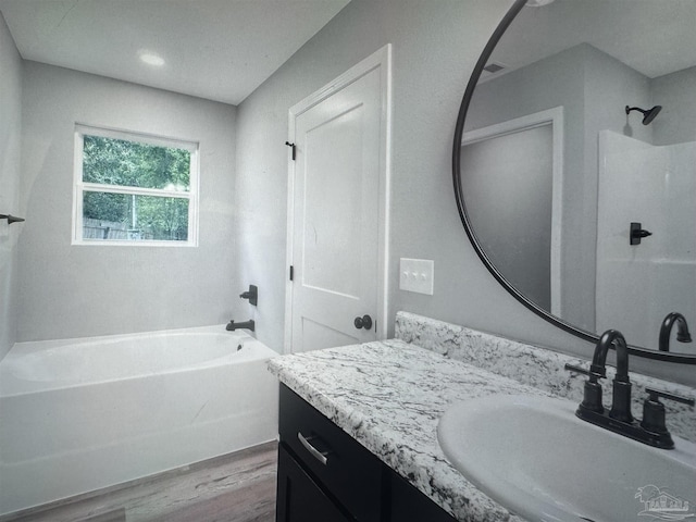 4796 Guernsey Rd, Pace, FL 32571 - bathroom featuring wood finished floors, a tub to relax in, and vanity