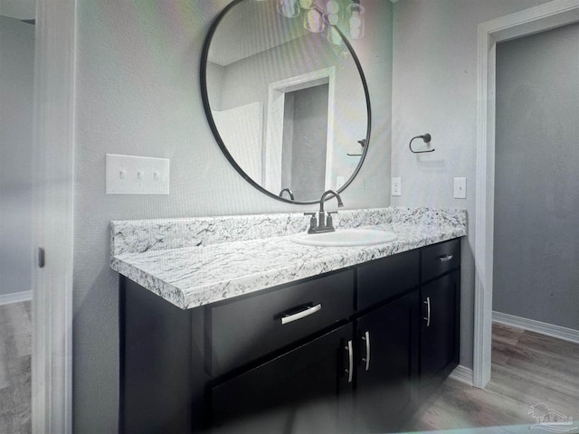 4796 Guernsey Rd, Pace, FL 32571 - bathroom with vanity, wood finished floors, and baseboards