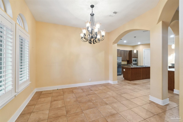 interior space featuring light tile patterned floors and an inviting chandelier