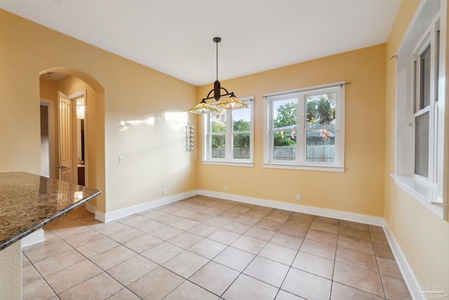 unfurnished dining area featuring light tile patterned floors