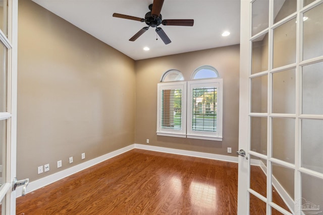 unfurnished room featuring french doors, wood-type flooring, and ceiling fan