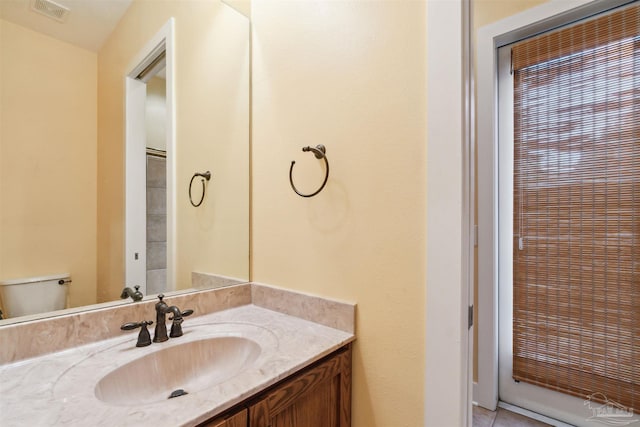 bathroom with vanity, toilet, and tile patterned floors