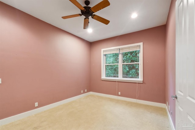 carpeted spare room featuring ceiling fan