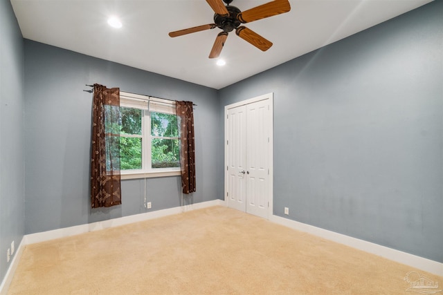 empty room with carpet and ceiling fan