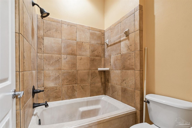 bathroom featuring tiled shower / bath and toilet