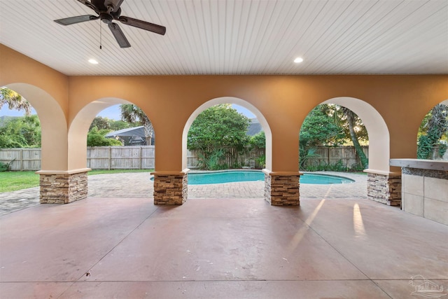 view of patio with a fenced in pool and ceiling fan