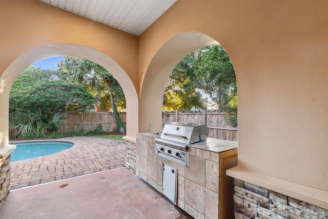 view of patio featuring area for grilling and a fenced in pool